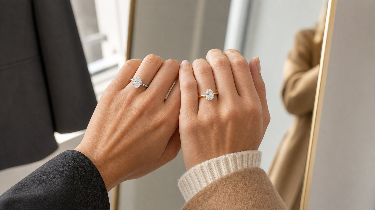 White gold and yellow gold diamond engagement rings worn side by side in a mirror styling moment.