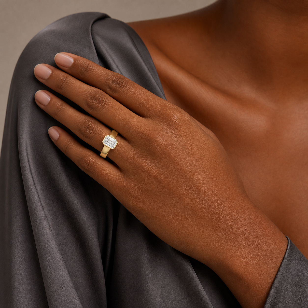 Emerald Wide Tapered Bezel Solitaire in 14K Yellow Gold wearing
