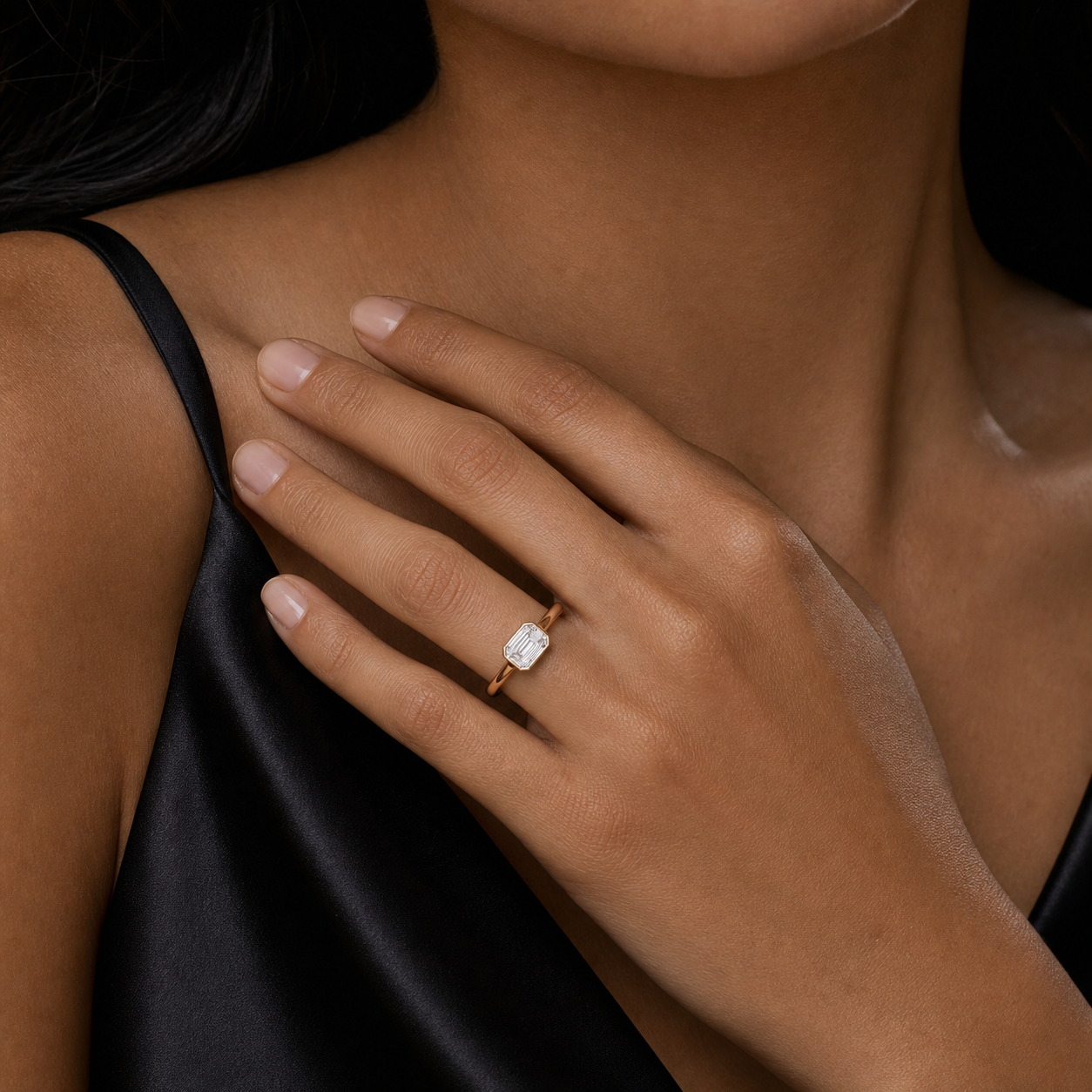 Emerald East-West Bezel Solitaire in 18K Yellow Gold wearing