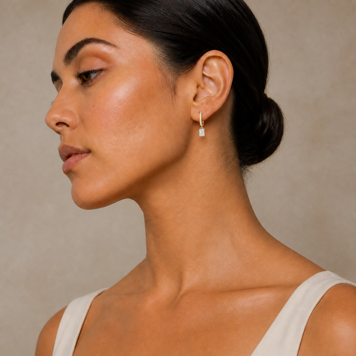 Fiorella Emerald Accented Drop Huggie Hoop Lab-Grown Diamond Earrings in 14K Yellow Gold, worn on ear