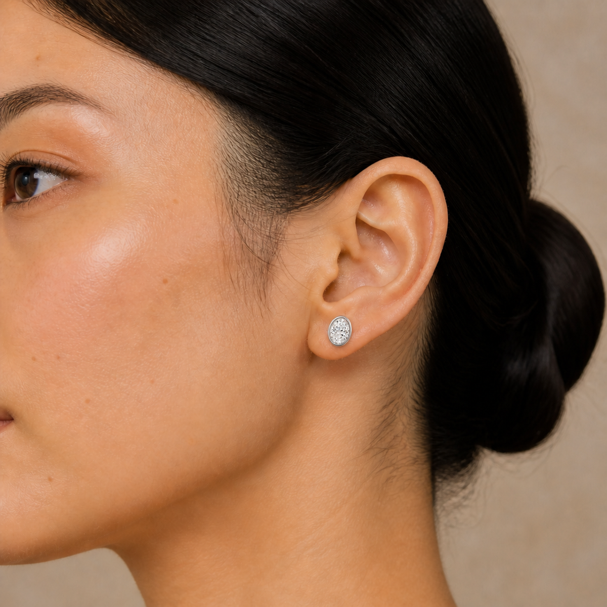 Jolie Oval Bezel Solitaire Lab-Grown Diamond Stud Earrings in 14K White Gold, worn on ear