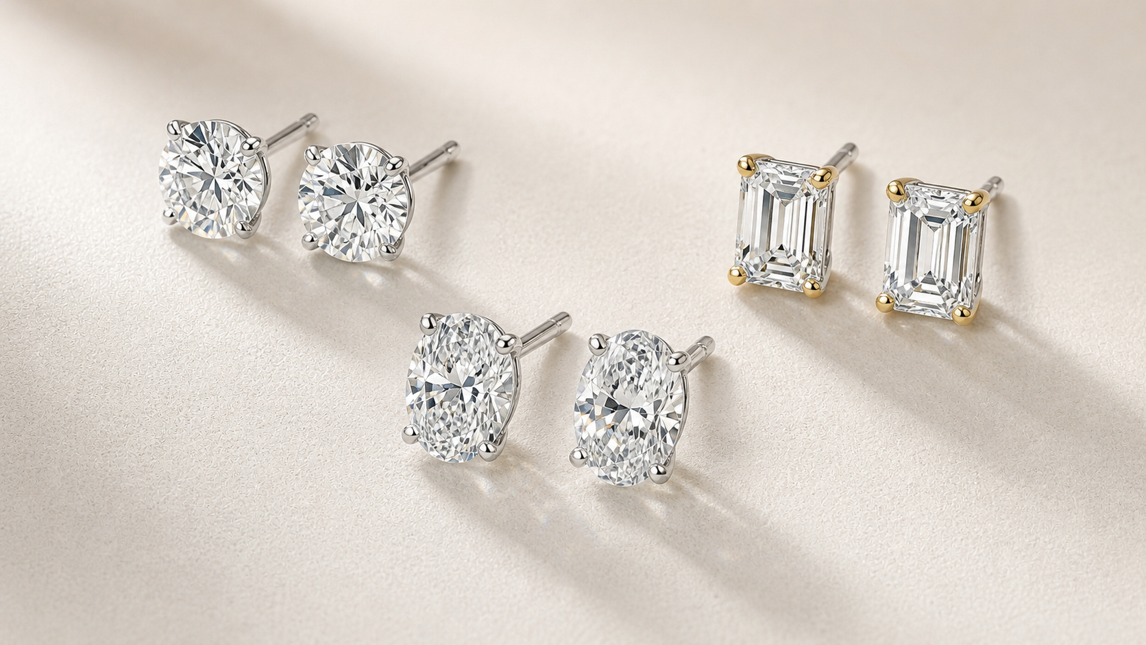 Lab-grown diamond stud earring pairs arranged in round, oval, and emerald styles.