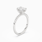 Oval Hidden Halo Accent Petite Pavé in 18K White Gold angled