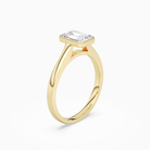 Emerald Medium Tapered Bezel Solitaire in 14K Yellow Gold angled