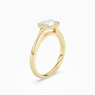 Emerald East-West Bezel Solitaire in 18K Yellow Gold angled