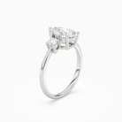 Pear Classic Round Three Stone Large Sides in Platinum angled