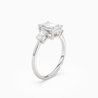 Emerald Classic Three Stone in Platinum angled