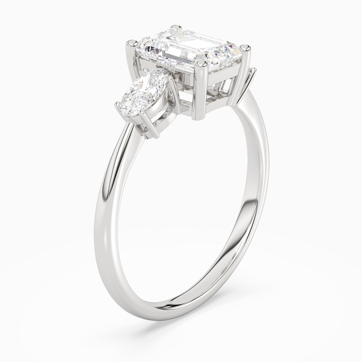 Emerald Classic Three Stone in Platinum angled