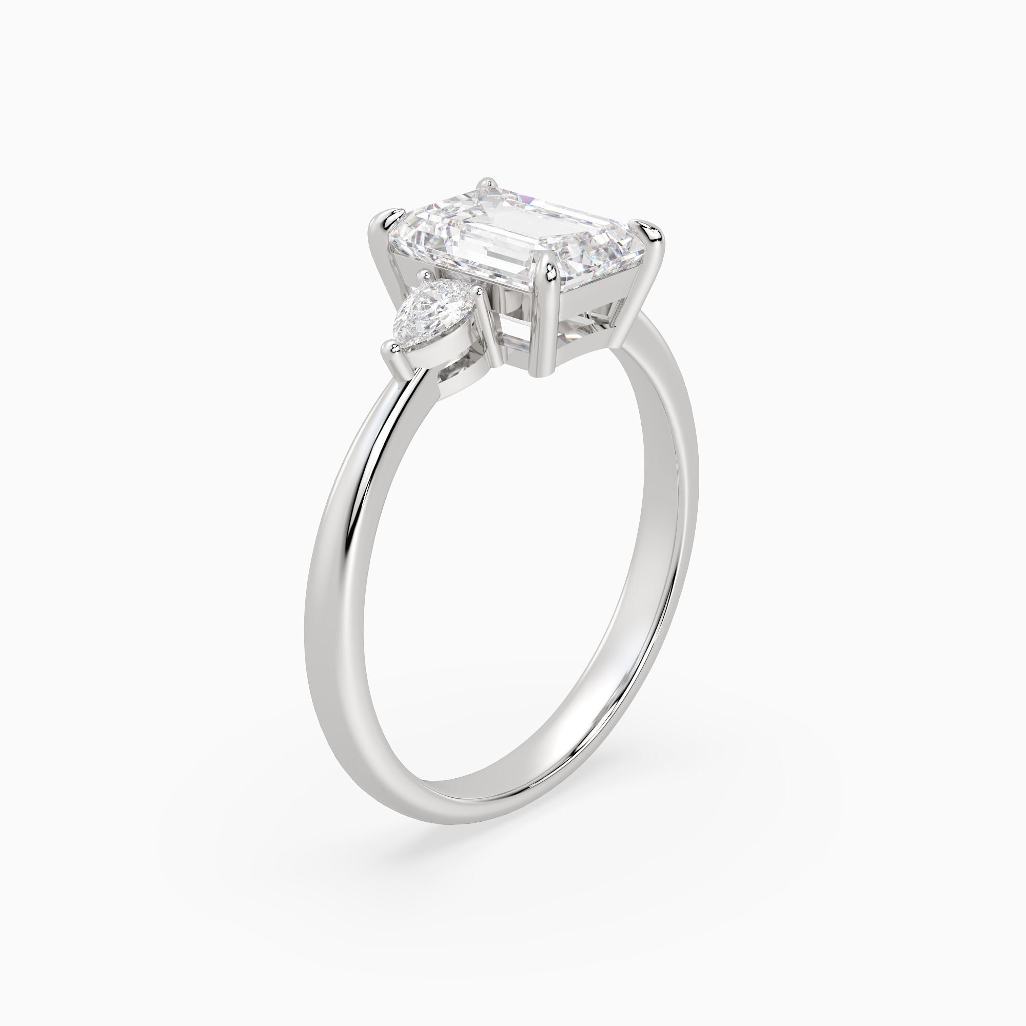 Emerald Pear Side Three Stone Classic in 18K White Gold angled