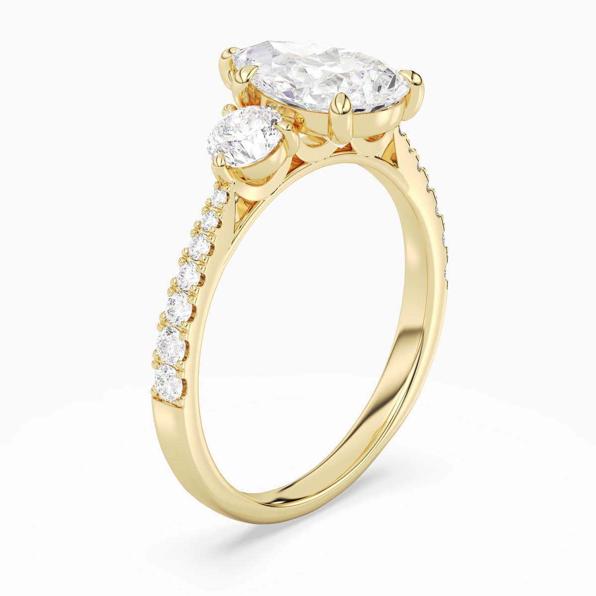 Pear Round Side Three Stone Pavé in 18K Yellow Gold angled