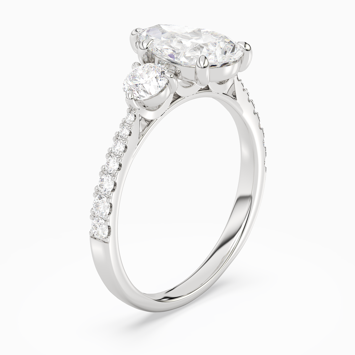Pear Round Side Three Stone Pavé in Platinum angled