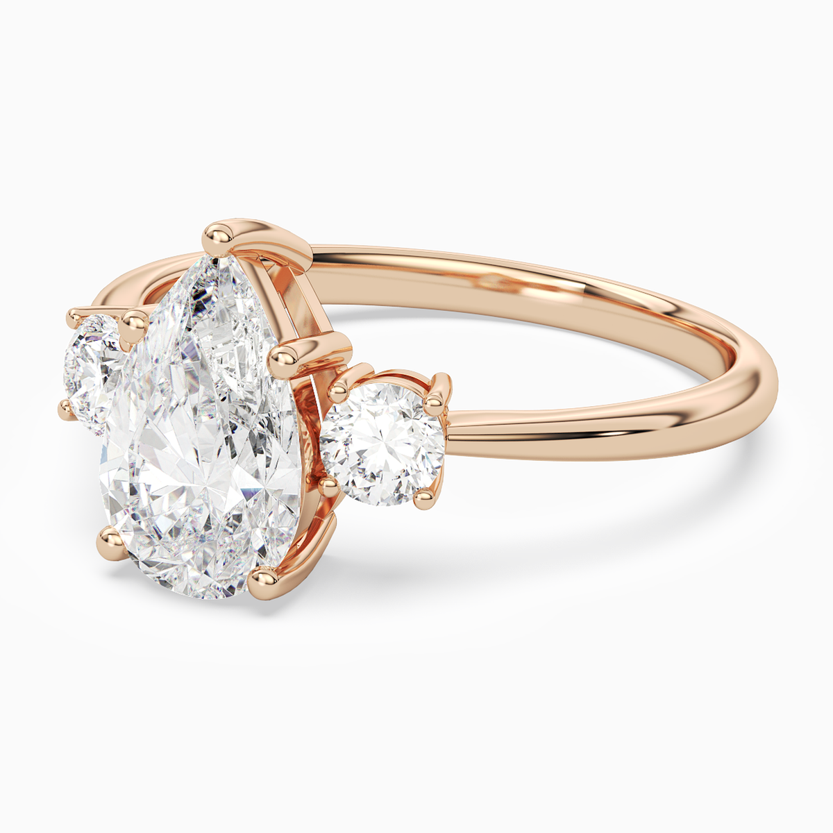 Pear Classic Round Three Stone Large Sides in 14K Rose Gold top angle