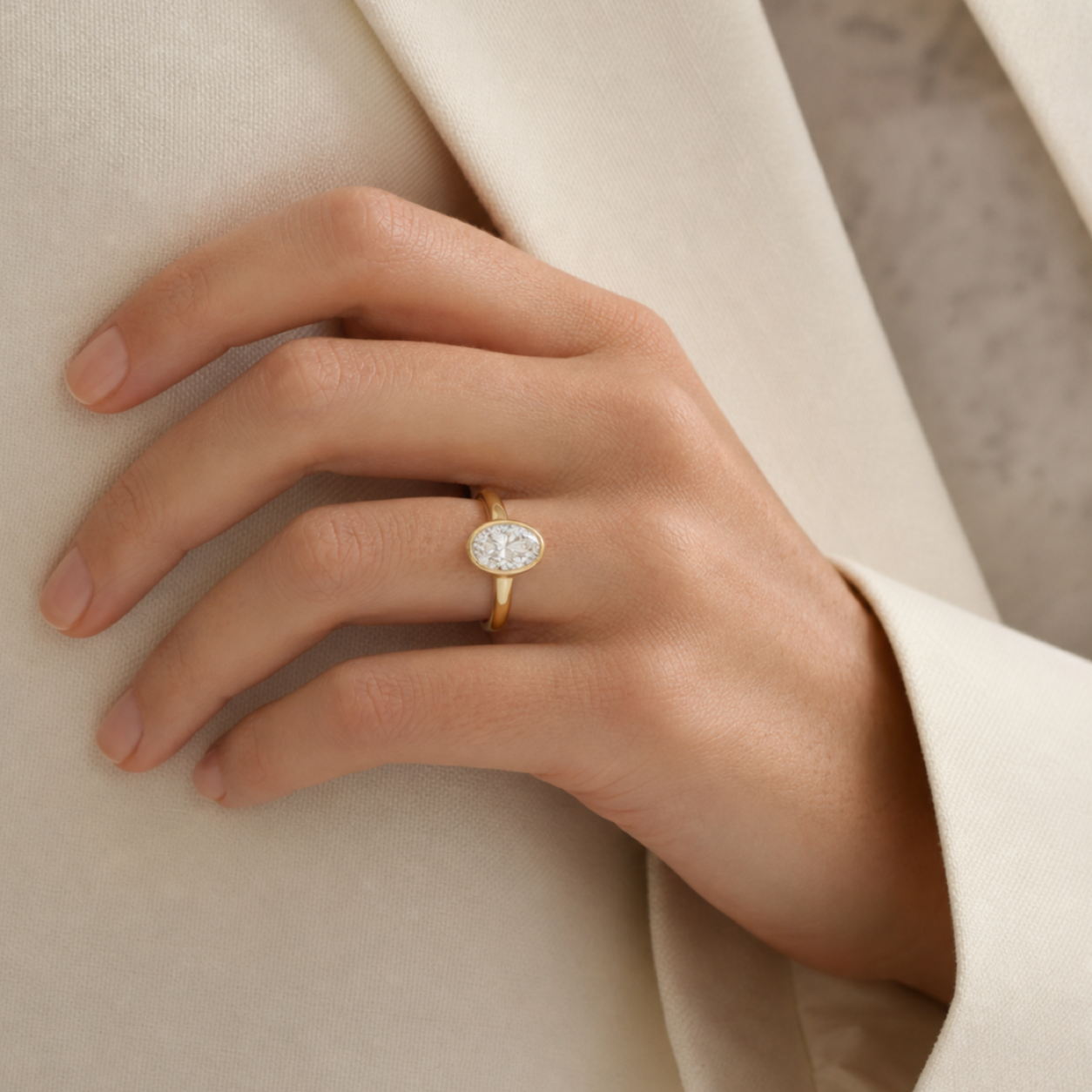 Oval Slim Tapered Bezel Solitaire in 18K Yellow Gold wearing