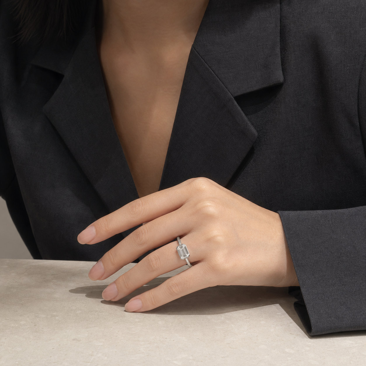 Emerald East-West Bezel Solitaire in Platinum wearing