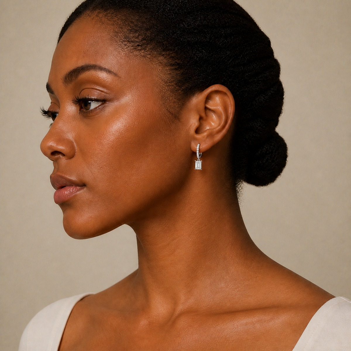 Fiorella Emerald Accented Drop Huggie Hoop Lab-Grown Diamond Earrings in 18K White Gold, worn on ear