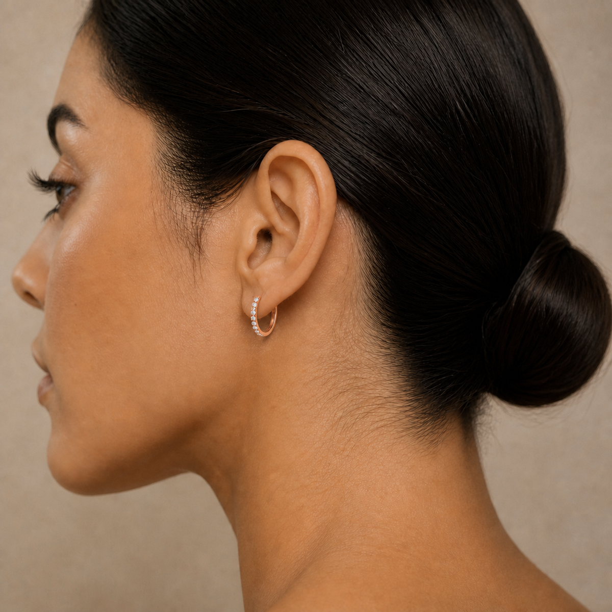 Xanthe Shared Prong Huggie Hoop Lab-Grown Diamond Earrings in 14K Rose Gold, worn on ear