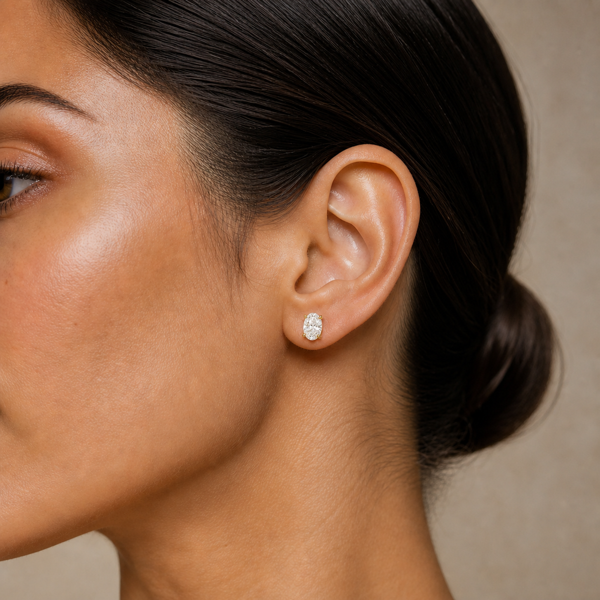 Eira Oval Solitaire 4-Prong Lab-Grown Diamond Stud Earrings in 14K Yellow Gold, worn on ear