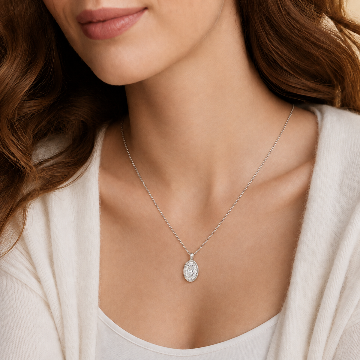 Stellaire Oval Bezel Solitaire Lab-Grown Diamond Pendant Necklace in Platinum, worn on neck
